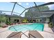 Spacious pool area surrounded by lush landscaping with ample seating and lounging options at 1810 Pine Hill Dr, Safety Harbor, FL 34695