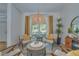 Bright sitting area with four chairs, round table, and natural light at 1810 Pine Hill Dr, Safety Harbor, FL 34695