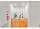 Wet bar with granite countertop, decorative backsplash, and wooden cabinets at 1810 Pine Hill Dr, Safety Harbor, FL 34695