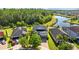 Aerial view of a beautiful home with mature landscaping, complemented by a serene lake backdrop at 19309 Prairie Tree Pl, Tampa, FL 33647