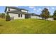Expansive backyard featuring well-maintained lawn and fenced perimeter, ideal for outdoor activities and privacy at 19309 Prairie Tree Pl, Tampa, FL 33647