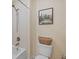 Bathroom with a shower/tub combination and a modern toilet with a decorative basket on top at 19309 Prairie Tree Pl, Tampa, FL 33647