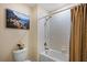 Bathroom with tub and shower combination and a framed picture of a beach scene at 19309 Prairie Tree Pl, Tampa, FL 33647