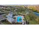 Aerial view of the community pool and clubhouse, surrounded by palm trees and lush landscaping at 19309 Prairie Tree Pl, Tampa, FL 33647