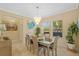 Dining room with a modern chandelier, a large window, and neutral-toned walls at 19309 Prairie Tree Pl, Tampa, FL 33647