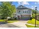 Charming two-story home featuring a brick-paved driveway and manicured lawn at 19309 Prairie Tree Pl, Tampa, FL 33647