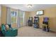 Bright game room with arcade games, television and a comfortable couch near the large windows at 19309 Prairie Tree Pl, Tampa, FL 33647