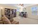 Bright home office with bookshelves and a large window, creating a productive workspace at 19309 Prairie Tree Pl, Tampa, FL 33647