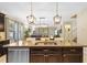 Spacious kitchen island featuring granite countertops, a stainless steel sink, and pendant lighting at 19309 Prairie Tree Pl, Tampa, FL 33647