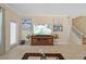 Inviting living area with tile flooring, a large TV, staircase and elegant artwork at 19309 Prairie Tree Pl, Tampa, FL 33647
