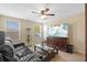 Cozy living room featuring a comfortable sofa, flat screen TV, and plenty of natural light at 19309 Prairie Tree Pl, Tampa, FL 33647