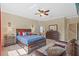 Main bedroom with carpeted floors, a ceiling fan, and an en-suite bathroom at 19309 Prairie Tree Pl, Tampa, FL 33647
