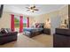 Comfortable main bedroom with large windows, soft carpet, and warm, inviting decor at 19309 Prairie Tree Pl, Tampa, FL 33647