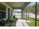 Relaxing screened patio with wicker furniture and view of the backyard at 19309 Prairie Tree Pl, Tampa, FL 33647