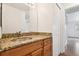 Charming bathroom featuring granite vanity, a decorative mirror, and ample storage for essentials at 200 Country Club Dr # 308, Largo, FL 33771