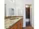 Bathroom features granite countertop and tiled shower with glass shower door at 200 Country Club Dr # 308, Largo, FL 33771