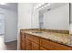 Bathroom vanity featuring a granite countertop and modern lighting at 200 Country Club Dr # 308, Largo, FL 33771