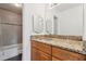 Bathroom showcases granite vanity, a framed mirror, and a shower/tub combo with tiled surround at 200 Country Club Dr # 308, Largo, FL 33771