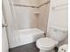 Bathroom featuring a tub with tile surround, a shower curtain, and a white toilet for convenience at 200 Country Club Dr # 308, Largo, FL 33771