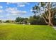 A large green space with a pond and trees offers a serene atmosphere for relaxation and enjoyment at 200 Country Club Dr # 308, Largo, FL 33771