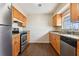 Efficient kitchen features stainless steel appliances, wood cabinets, and tile backsplash for a modern touch at 200 Country Club Dr # 308, Largo, FL 33771