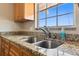 Updated kitchen featuring granite countertops, stainless steel sink, updated faucet and pleasant natural light at 200 Country Club Dr # 308, Largo, FL 33771