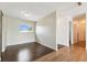 Living room with hardwood floors and a window overlooking the yard, creating a cozy and inviting space at 200 Country Club Dr # 308, Largo, FL 33771