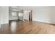 Spacious living area with new flooring, neutral paint, and plentiful natural light and view into the kitchen at 200 Country Club Dr # 308, Largo, FL 33771
