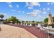 A pool deck with many lounge chairs and tables for entertaining offers tranquil pond views at 200 Country Club Dr # 308, Largo, FL 33771