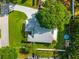 An aerial view of the property showcases the roof, lush backyard with an above-ground pool, and surrounding trees at 22304 Stillwood Dr, Land O Lakes, FL 34639