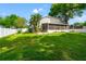 The backyard features lush grass, landscaping, a screened lanai, and a fenced yard at 22304 Stillwood Dr, Land O Lakes, FL 34639