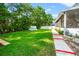 A lush backyard with green grass, mature trees, landscaping and an above-ground pool offers a private outdoor retreat at 22304 Stillwood Dr, Land O Lakes, FL 34639