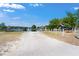 Gravel boat ramp leading into a lake with a wooden dock on a sunny day at 22304 Stillwood Dr, Land O Lakes, FL 34639