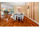 Spacious dining room with hardwood floors, and white trim, open to the living room at 22304 Stillwood Dr, Land O Lakes, FL 34639