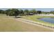Equestrian property featuring enclosed riding area, horse stables and pond surrounded by mature trees at 22304 Stillwood Dr, Land O Lakes, FL 34639