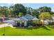 Charming single-story home with a landscaped yard, manicured bushes, and a concrete driveway at 22304 Stillwood Dr, Land O Lakes, FL 34639