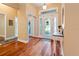 Welcoming foyer with hardwood floors, white trim, glass door, and a coat closet at 22304 Stillwood Dr, Land O Lakes, FL 34639