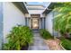 Welcoming front entrance with glass front door and landscaped garden beds at 22304 Stillwood Dr, Land O Lakes, FL 34639