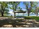 Gazebo overlooking a serene lake, complete with picnic table and grill at 22304 Stillwood Dr, Land O Lakes, FL 34639