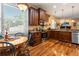 Kitchen features dark wood cabinets, granite counters, stainless appliances, and a view to the living room at 22304 Stillwood Dr, Land O Lakes, FL 34639