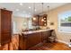 Kitchen with dark brown cabinetry, granite countertops, stainless steel appliances, and view of eat-in dining area at 22304 Stillwood Dr, Land O Lakes, FL 34639