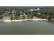 Overhead view of lakefront with sandy beach, trees, and docks at 22304 Stillwood Dr, Land O Lakes, FL 34639