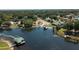 Aerial view of a lake and the surrounding homes, featuring private docks and lush vegetation at 22304 Stillwood Dr, Land O Lakes, FL 34639