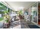 A covered lanai with comfortable seating, a grill, potted plants, and a view of the backyard at 22304 Stillwood Dr, Land O Lakes, FL 34639