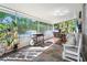 A covered lanai with comfortable seating, a grill, potted plants, and a view of the pool at 22304 Stillwood Dr, Land O Lakes, FL 34639