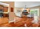 Spacious living room features hardwood floors, a stone fireplace, neutral furniture, with kitchen in background at 22304 Stillwood Dr, Land O Lakes, FL 34639