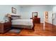 Spacious main bedroom featuring hardwood floors, a large dresser, and light blue walls at 22304 Stillwood Dr, Land O Lakes, FL 34639