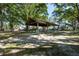 Large picnic shelter with ample seating, nestled under mature trees for outdoor gatherings at 22304 Stillwood Dr, Land O Lakes, FL 34639