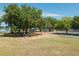 Community playground with swings, slides, and picnic shelter surrounded by mature trees at 22304 Stillwood Dr, Land O Lakes, FL 34639