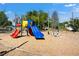 Outdoor playground with slides, swings, and seating area for community enjoyment at 22304 Stillwood Dr, Land O Lakes, FL 34639